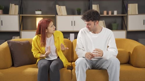 Couple Arguing and Reconciling on a Couch