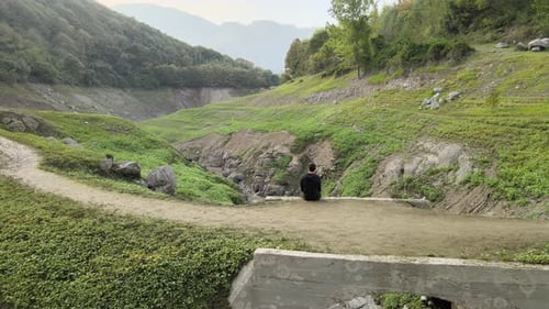 alone man on stone bridge