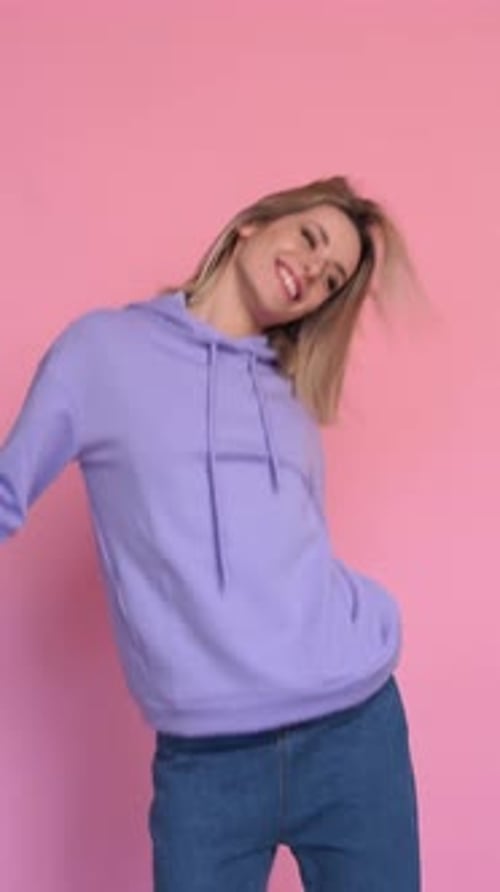 Cheerful Young Woman Dancing in Studio