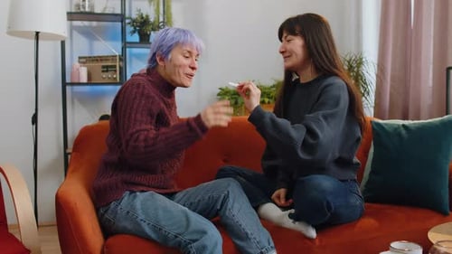 Two Women Reacting to Positive Pregnancy Test