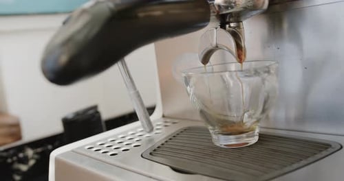 Close up of coffee machine with cup of coffee at coffee shop, slow motion