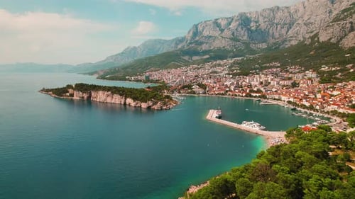 Coastal gem in Croatia. A picturesque seaside town nestles at the foot of a majestic mountain, fring
