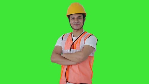 Portrait of Happy Indian labour standing crossed hands Green screen