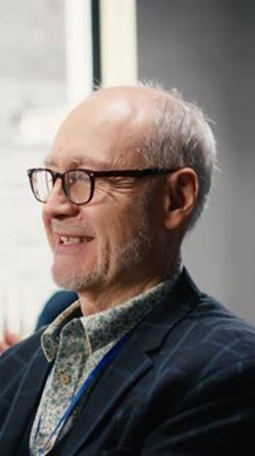 Smiling man at corporate event, side view