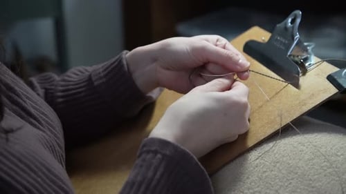 Woman's Hands Knotting Thin String Art