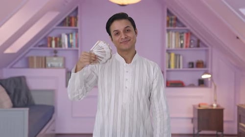 Young Adult Holding Money Indoors