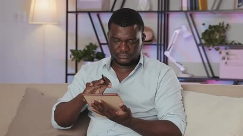Black Man Using Digital Tablet when Working from Home