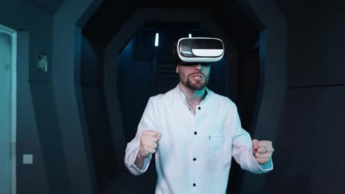 Man Wearing VR Headset Gesturing in Futuristic Tunnel