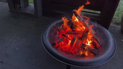 Burning fire in a metal pit at night