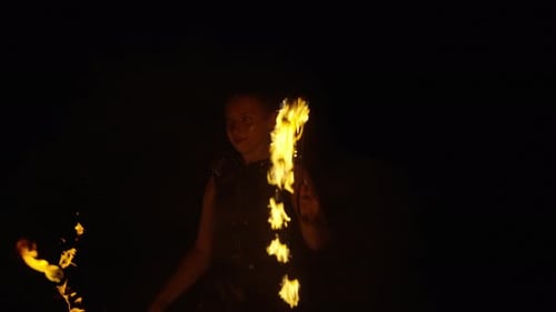 Young Woman Performing a Fire Dance at Night