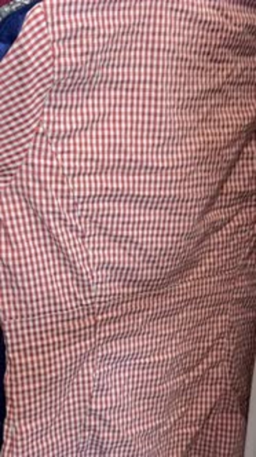 Closeup of a Woman in a Store Looking at a Sale of Clothes Sale of Promotional Clothing Vertical