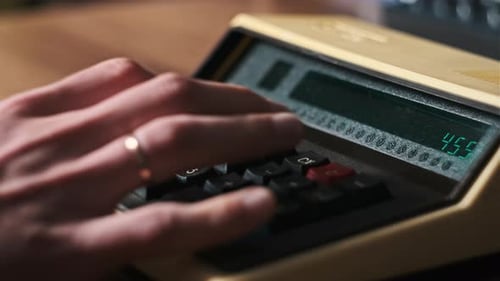 Male Hand Press Buttons on an Old Retro Calculating Machine CloseUp