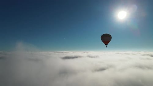 First Person Aerial View of Beautiful Air Hot Balloon Flying High in the Clouds During Sunny Hot