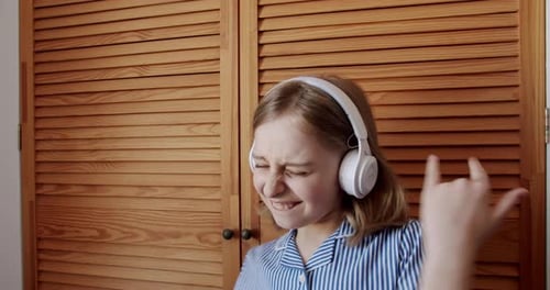 Happy Child Dancing to Music With Headphones