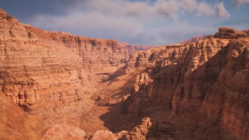 Bright Sandstone Formations with Shadowed Ravines and Distant Plateau