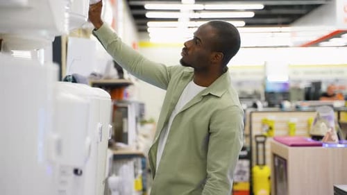 Customer Choosing Air Conditioner in Electronics Store