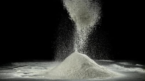 Powdered Flour Falling, Pile Forming on Dark Surface
