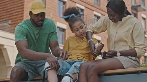 Parents Prepare Daughter for Outdoor Activity in City