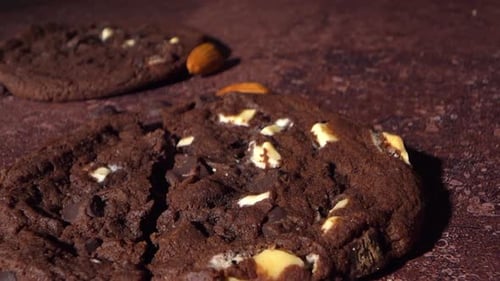 Cookie Breaking Open Showing Soft Center With Almond Pieces