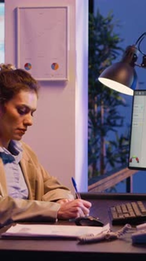 Vertical Video Executive Manager Analyzing Graphs on Report
