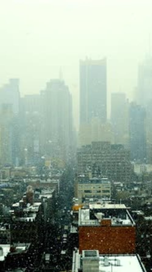 A Foggy Urban Scene That Offers a Stunning Overlook of the Cityscape Below and Beyond