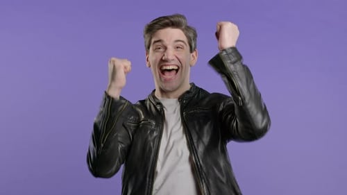 Excited Man Celebrating Success With Fists Raised