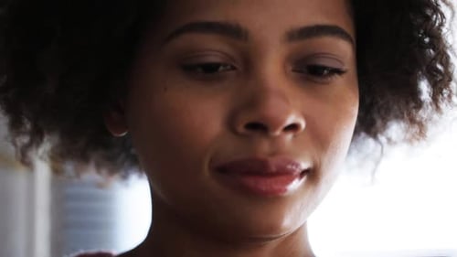 Woman Looking Down at Cell Phone, Indoors
