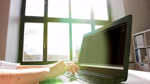 Business, Technology and People Concept - Female Programmer Working on Computer At