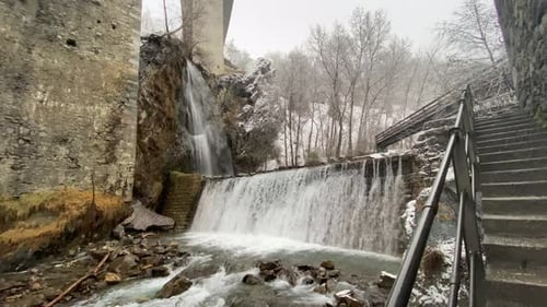 Picturesque Waterfall Flowing in Winter Landscape