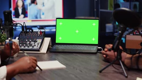 Green Screen Laptop Next to Cohosts Streaming Podcast Using Professional Vlogging Gadgets