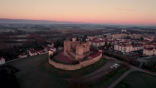 drone shot approaching Montrond les bains Castle during the sunrise with a beautiful golden hour, Pl