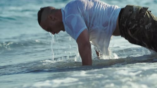 Soldier Does Push Ups in the Sea Waves