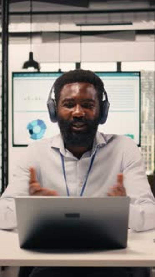 Vertical Video Black Professional Attending Video Conference with Headphones