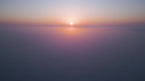 Sunrise Above a Vast Sea of Clouds The Golden Light Gently Illuminates the Misty Sky Creating a