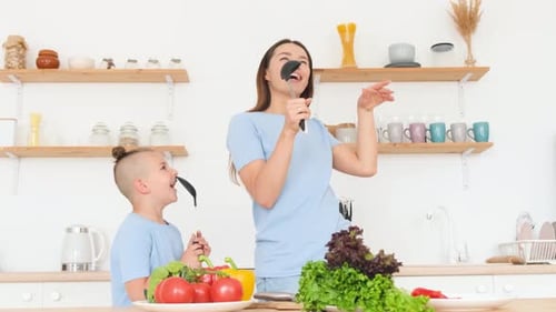 Mother and Son Sing and Dance in Kitchen