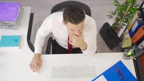 Man Celebrating Success While Working at Desk