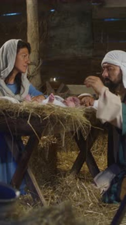 Mary and Joseph Speaking and Taking Care of Baby Jesus