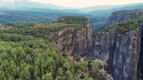 Beautiful Aerial Shots of Mountain Canyons with a Green Forest on Them