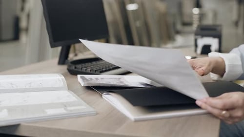 Tile designer reviews documents in salon