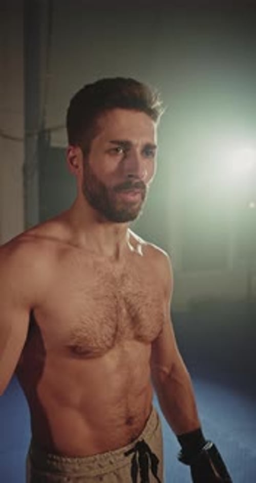 Boxer with Gloves Standing in Gym