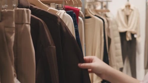 Female Hands Choosing Clothes in a Clothing Store Shop Shopping Concept