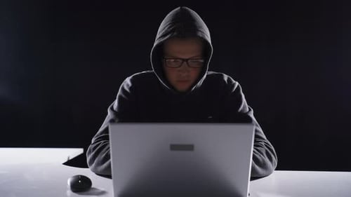 Young Adult Using Laptop in the Dark