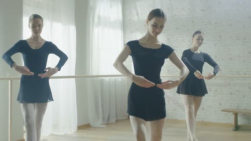 Three Young Women Practicing Ballet in Dance Studio