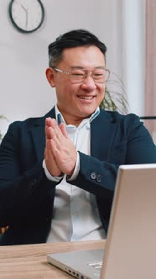 Asian Businessman Freelancer at Office Workplace Working on Laptop Computer Sends Online Messages