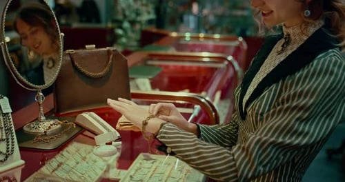 Woman Trying Gold Bracelet with Brilliants in Jewelry Store in 19 Century Prores