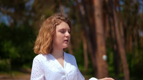 Woman Singing Outdoors in Forest