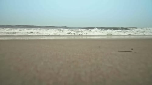 Ocean waves crashing into camera on beach in Dewey Beach, Delaware