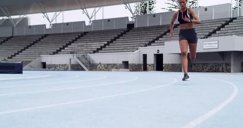 Fitness, stadium and woman running on a track training for a race, competition or marathon