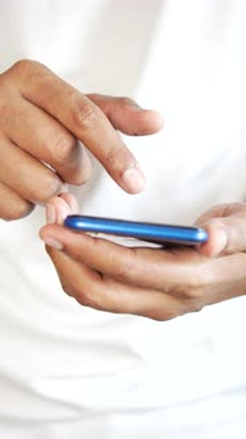Vertical Shot of Close Up of Young Man Hand Using Smart Phone