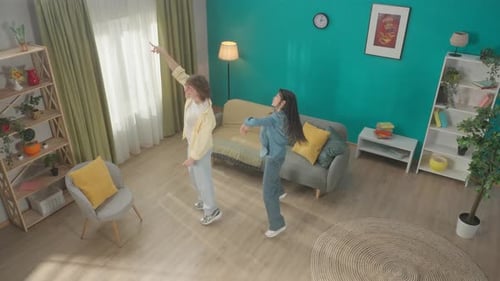 A Curly Guy and a Young Asian Woman Spend Time Together at Home on a Day Off Young Couple Having Fun